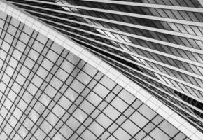 Fragment of a modern office building. Abstract geometric background. Part of a skyscraper with glass windows. Black and white. photo