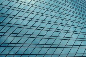 Fragment of a modern office building. Abstract geometric background. Part of a skyscraper with glass windows. photo
