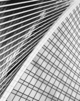 Fragment of a modern office building. Abstract geometric background. Part of a skyscraper with glass windows. Black and white. photo