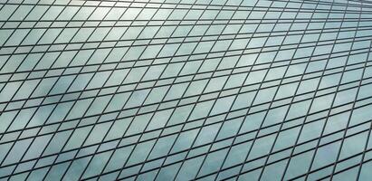 Fragment of a modern office building. Abstract geometric background. Part of a skyscraper with glass windows. photo