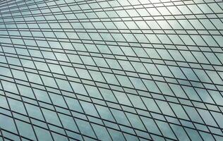 Fragment of a modern office building. Abstract geometric background. Part of a skyscraper with glass windows. photo