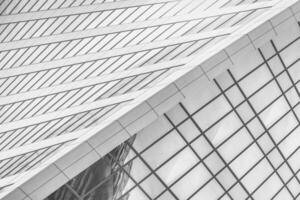 Fragment of a modern office building. Abstract geometric background. Part of a skyscraper with glass windows. Black and white. photo