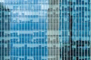 Fragment of a modern office building. Abstract geometric background. Part of a skyscraper with glass windows. photo