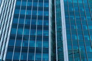 Fragment of a modern office building. Abstract geometric background. Part of a skyscraper with glass windows. photo