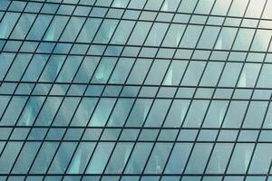 Fragment of a modern office building. Abstract geometric background. Part of a skyscraper with glass windows. photo