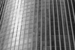 Fragment of a modern office building. Abstract geometric background. Part of a skyscraper with glass windows. Black and white. photo