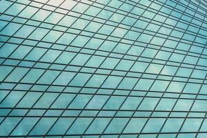 Fragment of a modern office building. Abstract geometric background. Part of a skyscraper with glass windows. photo