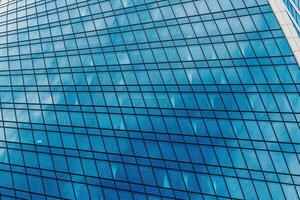 Fragment of a modern office building. Abstract geometric background. Part of a skyscraper with glass windows. photo