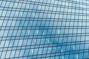 Fragment of a modern office building. Abstract geometric background. Part of a skyscraper with glass windows. photo
