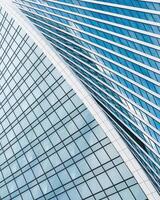 Fragment of a modern office building. Abstract geometric background. Part of a skyscraper with glass windows. photo