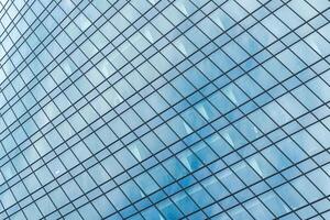 Fragment of a modern office building. Abstract geometric background. Part of a skyscraper with glass windows. photo
