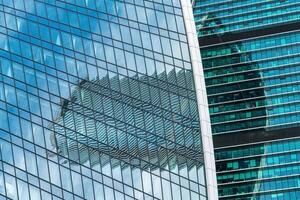 Fragment of a modern office building. Abstract geometric background. Part of a skyscraper with glass windows. photo