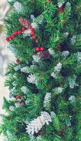 Christmas toy cones and berries on an artificial spruce. photo