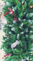 Christmas toy cones and berries on an artificial spruce. photo