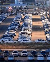 Volkswagen, Russia, Kaluga - JULY 14, 2022 New cars parked at distribution center automobile factory at night with lights. photo
