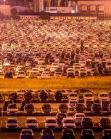 Volkswagen, Russia, Kaluga - AUGUST 26, 2020 New cars parked at distribution center automobile factory at night with lights. Parking on the open air. photo