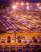 Volkswagen, Russia, Kaluga - AUGUST 26, 2020 New cars parked at distribution center automobile factory at night with lights. Parking on the open air. photo