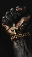Empowering African American design Fist holding gold chain with cross pendant. photo