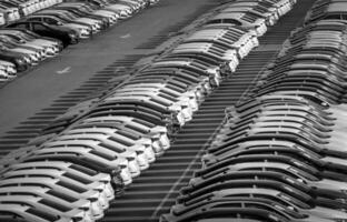 Volkswagen Group Rus, Russia, Kaluga - MAY 24, 2020 Rows of a new cars parked in a distribution center on a day in the spring, a car factory. Parking in the open air. Black and white photo. photo