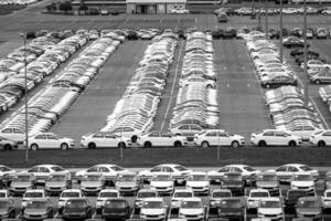 Volkswagen Group Rus, Russia, Kaluga - MAY 24, 2020 Rows of a new cars parked in a distribution center on a day in the spring, a car factory. Parking in the open air. Black and white photo. photo