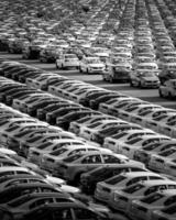 Volkswagen Group Rus, Russia, Kaluga - MAY 24, 2020 Rows of a new cars parked in a distribution center on a day in the spring, a car factory. Parking in the open air. Black and white photo. photo
