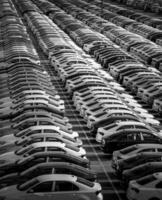 Volkswagen Group Rus, Russia, Kaluga - MAY 24, 2020 Rows of a new cars parked in a distribution center on a day in the spring, a car factory. Parking in the open air. Black and white photo. photo