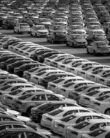 Volkswagen Group Rus, Russia, Kaluga - MAY 24, 2020 Rows of a new cars parked in a distribution center on a day in the spring, a car factory. Parking in the open air. Black and white photo. photo