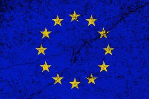 European Union flag on cracked concrete wall. The concept of crisis, default, economic collapse, pandemic, conflict, terrorism or other problems in the country. Abstract disaster symbol. photo