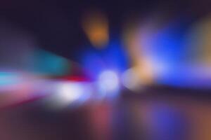Blurred lights of headlights of cars and lanterns in the night city. Abstract bokeh. photo