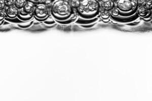 Monochrome background with air bubbles in the liquid. Carbonated drinks. Abstract backdrop. photo