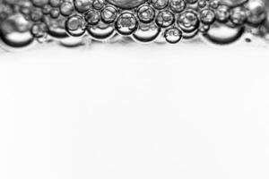 Monochrome background with air bubbles in the liquid. Carbonated drinks. Abstract backdrop. photo