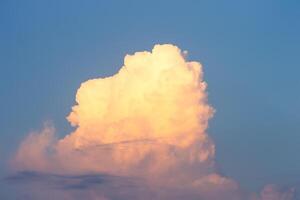 Bright blue sky with cumulus clouds lit by the morning sun. Abstract background. photo