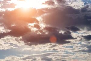 Sun rays breaking through cumulus clouds. The concept of divine light, a glimmer of hope or overcoming difficulties. Spiritual religious background. photo