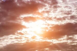 Sun rays breaking through cumulus clouds. The concept of divine light, a glimmer of hope or overcoming difficulties. Spiritual religious background. photo