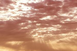 Sun rays breaking through cumulus clouds. The concept of divine light, a glimmer of hope or overcoming difficulties. Spiritual religious background. photo