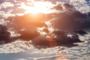 Sun rays breaking through cumulus clouds. The concept of divine light, a glimmer of hope or overcoming difficulties. Spiritual religious background. photo