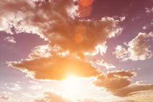 Sun rays breaking through cumulus clouds. The concept of divine light, a glimmer of hope or overcoming difficulties. Spiritual religious background. photo