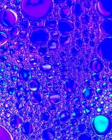 Top view on colorful drops of oil on the water. Circles and ovals. photo