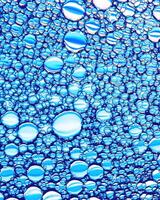 Top view on colorful drops of oil on the water. Circles and ovals. photo