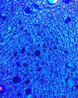 Top view on colorful drops of oil on the water. Circles and ovals. photo