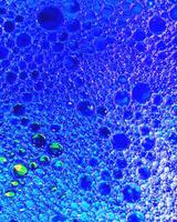 Top view on colorful drops of oil on the water. Circles and ovals. photo