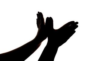 Silhouette of hands showing flying bird wings gesture isolated on white background. Blank for design. photo