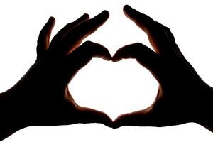Silhouette of hands showing heart gesture isolated on white background. Blank for design. photo