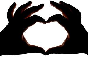 Silhouette of hands showing heart gesture isolated on white background. Blank for design. photo