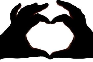 Silhouette of hands showing heart gesture isolated on white background. Blank for design. photo