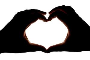 Silhouette of hands showing heart gesture isolated on white background. Blank for design. photo