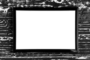 Black photo frame on a wooden table. Abstract background for design. Art stylized baner or mock up with copy space.