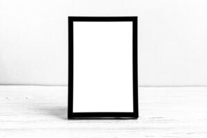 White wooden floor over concrete or decorative plaster wall and black photo frame with copy space for a text background. Mock up.