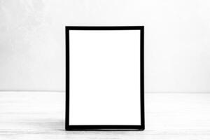White wooden floor over concrete or decorative plaster wall and black photo frame with copy space for a text background. Mock up.