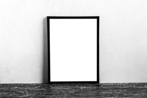 Wooden floor over concrete or decorative plaster wall and black photo frame with copy space for a text background. Mock up.